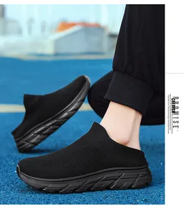 Close-up of black breathable knit sports sneakers on blue track featuring anti-slip soles