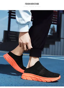 Close-up of breathable black knit mesh and thick orange anti-slip sole of sport mules