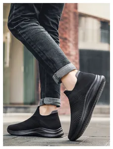 Detail of all-black breathable flyknit slip-on sneakers showing the slip-resistant thick sole