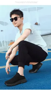 Close-up of black mesh slip-on running shoe with anti-slip sole shown on outdoor court