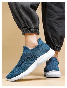 Detail shot of breathable blue knitted walking shoes with thick white cushioned soles