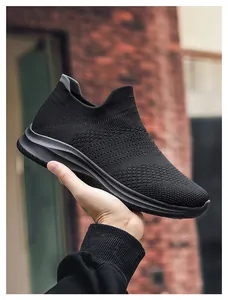 Detail of breathable knitted mesh fabric and sock-like design on black casual sneakers