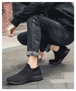 Close-up of black breathable mesh slip-on sneakers worn for outdoor trekking