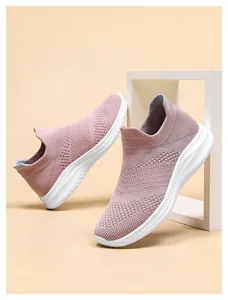 Detail of pink knitted mesh walking sneakers featuring a breathable slip-on design
