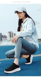 Detail of black knit slip-on sneakers with breathable mesh and white thick soles
