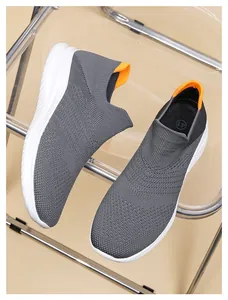 Close-up of grey breathable mesh sports shoes with orange pull tab and size 41 detail