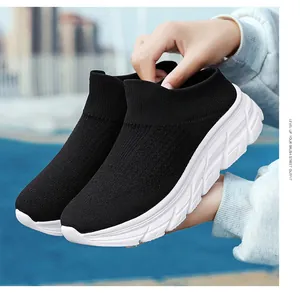 Detail of lightweight black knit slip-on sneaker with breathable mesh and thick white sole
