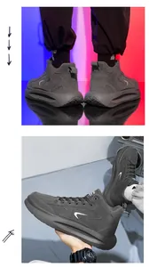 Dettaglio di sneaker alte uomo grigio scuro con suole spesse ammortizzate e finitura scamosciata