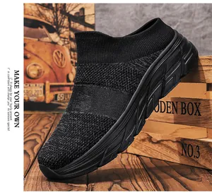 Detail of black breathable knit upper and thick wave patterned sole of slip-on shoes