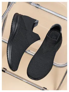 Top view of black knitted slip-on sneakers featuring breathable fabric texture and size 41