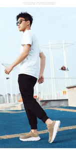 Outdoor shot of men's khaki slip-on knit running shoes with thick cushioned white soles