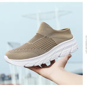 Detail of khaki breathable knitted slip-on sneakers with thick white lightweight soles