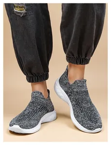 Detailed close-up of breathable knit sneaker texture and wavy white sole on foot