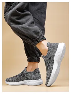 Detailed view of grey knit slip-on sneakers featuring a lightweight white cushioned sole