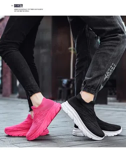Outdoor street view of pink and black knit mesh sneakers with thick cushioned soles