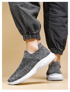 Close-up of gray knit slip-on sneakers with breathable fabric and thick white sole