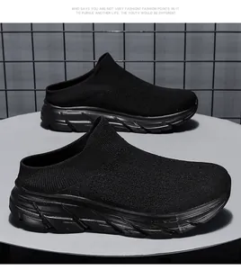 Detail of black breathable knit upper and thick shock-absorbing sole of slip-on mules