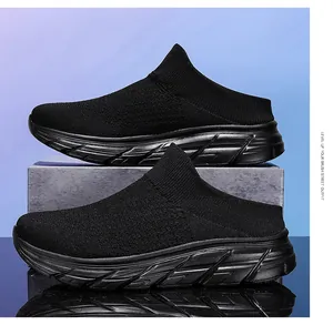 Detail view of black breathable fly-knit mesh slip-on mule sneakers with thick EVA soles