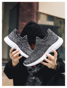 Detail view of black and grey knit walking shoes featuring breathable mesh and white EVA sole