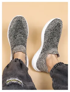 Detail of grey flyknit walking shoes showing breathable texture and thick white rubber sole