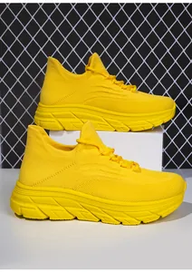 Nahaufnahme des atmungsaktiven Fly-Knit Obermaterials und der Sohle gelber Turnschuhe