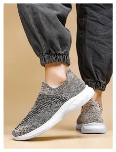 Detail of grey knitted sock sneakers with white wave textured soles on model