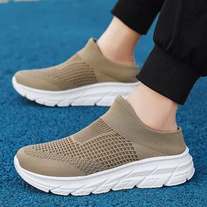 Khaki breathable knit sneaker mules with white thick sole on a blue running track