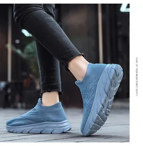 Detail of blue knitted slip-on walking shoe with shock-absorbing thick EVA sole for men