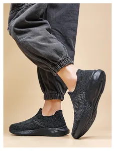 Close-up of black breathable knit slip-on sneaker with thick anti-slip wavy sole