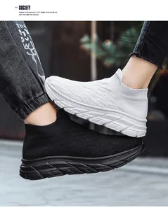 Detail of breathable knit texture and thick cushioned soles on black and white mesh shoes