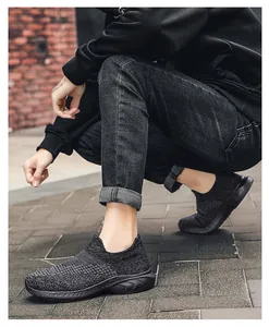 Detail of grey knitted sock sneakers featuring breathable mesh upper and slip-on design