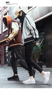 Street view of black and white breathable mesh slip-on sneakers with thick EVA soles