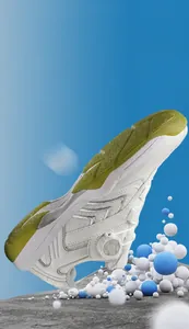 Detailed view of white badminton shoes with swivel buckle and green anti-slip rubber sole