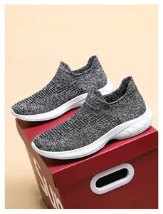 Detail of grey knitted mesh walking shoes with white platform sole and slip-on design