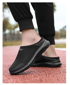 Detailed side view of black quilted winter slippers with thick plush lining and sport logo