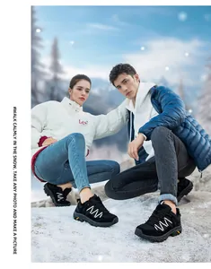 Detail of waterproof hiking shoes with non-slip soles on snow-covered ground