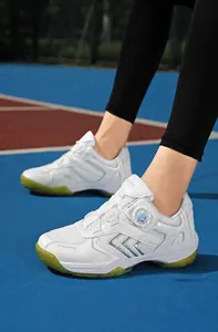 Detail of white athletic shoe with a rotary dial lacing system and silver accents