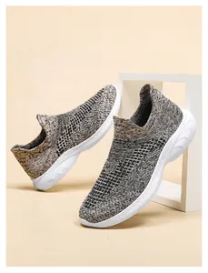 Detail of breathable knit fabric and thick white rubber sole on casual walking sneakers