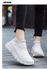 Detail view of white breathable mesh sneaker with thick cushioned sole and textured grip