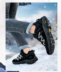 Detail of waterproof hiking boots with warm faux-fur lining on snowy outdoor ground