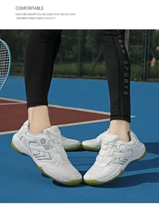 Detail view of white indoor court shoes with quick-lace dial and green rubber sole