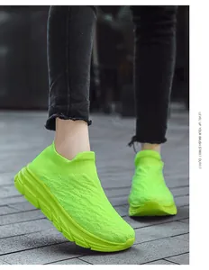 Detail of neon green knitted slip-on sneakers with breathable mesh and thick soles