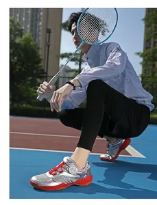 Detail of silver badminton shoe featuring a rotating dial lace system and non-slip sole
