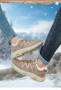 Detailed shot of winter outdoor hiking boots with warm faux fur lining and khaki mesh