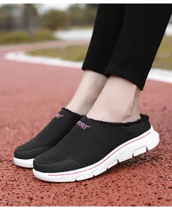 Detail of black winter mule slipper with soft plush lining and pink SPORT embroidery
