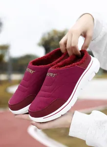 Detail of dark red winter home slipper showing thick fleece lining and durable rubber sole