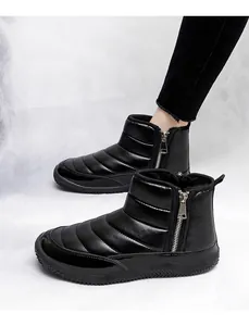 Detail of black quilted winter boots with side zipper and thick warm fleece lining