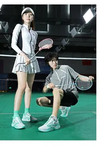 Group shot of athletic couple with professional badminton rackets and breathable court shoes