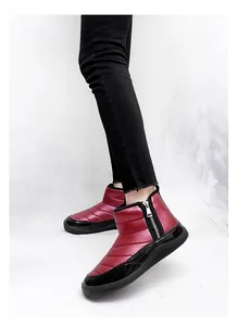 Detail view of burgundy quilted winter snow boots featuring a silver side zipper closure