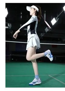Women's athletic outfit for badminton featuring a long sleeve top and pleated tennis skirt